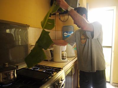 Roasting banana leaves for making pollo pibil