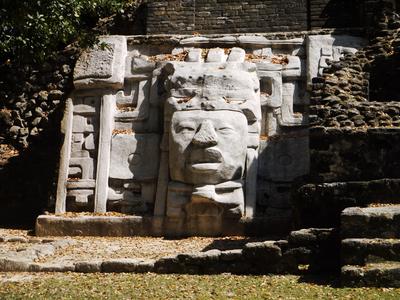 Lamanai. The carving is a reproduction placed in front of the original, which is lucky, since some visitors think nothing of touching or leaning on it.