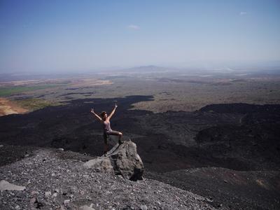 Behind the posing lady you can see the pumice from Cerro Negro's last eruption spilling over the landscape.