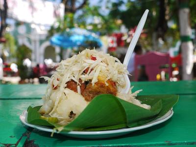 Pork with fried yuca on banana leaf, a typical local dish.