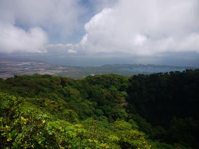 Hiking volcan Mombacho. The crater in the foreground, behind it the isletas (right) and Granada (left).