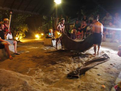 Extracting our dinner from the underground oven at the Tiki Village.