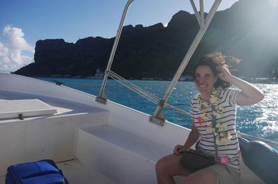 Dawn and Jocelyn greeted us with the obligatory flower necklaces, and took us to the pension in their boat. That square cliff face on the left is known as Mt. Hotu Parata.