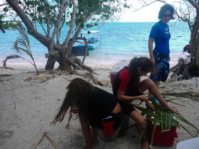 The girls made plates from pandanus leaves. They are from a French family from the metropole (mainland France) living in Tahiti.