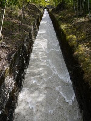 Water mains in the Pyrennes often look like this. You tap a high-altitude stream and send it down into town in a steep open chute, in the process creating the MOST AWESOME WATER SLIDE EVER. devinsupertramp, take note.