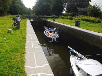 A couple of yachts passing through one of the locks. The control console for the lock is on the right.