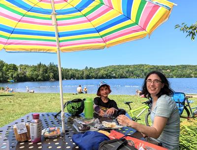 The lake <i>du jour</i>, at Saint-Faustin-Lac-Carré. We were surprised to find an unoccupied table with shade at the fairly busy beach. Then the owner of the shade came by to explain that it's her spot. And then she decided against evicting us, inviting us to join her instead.