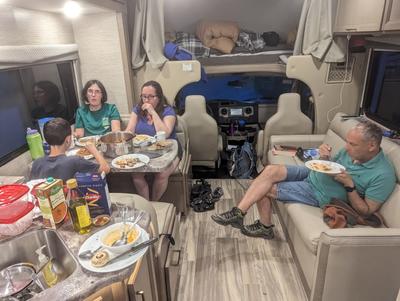 Typical dinner scene. At the top is Dana and Ron’s bed, the couch on the right opens into Adam’s bed, and the in-laws are in the “master bedroom” behind the camera.