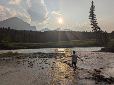 Bow river fun at the end of the day at the campsite in Banff, while Ilan works the grill