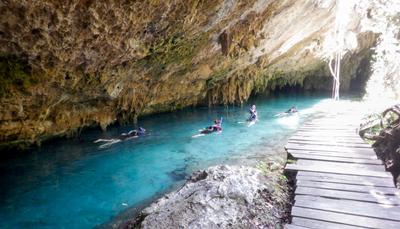 Cenote Sac Actun (White Cave). Publicly accessible cenotes are usually either swimming hole type, like Corazon del Paraiso, or adventure type, like this one. At the swimming holes you pay to enter and can hang out for as long as you wish. At Sac Actun you go with a guide, traversing a series of interconnected caves with karst formations and some animal remains. The tour took about an hour, which was approximately the right duration for me, and approximately an hour too long for Adam.