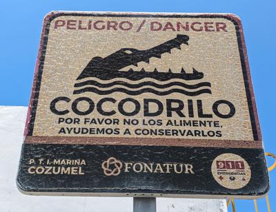 At the marina ahead of our snorkeling trip. When Adam pointed out this sign, I took it to mean "Please do not disturb the wildlife". He interpreted it as "You are about to be devoured".<br/>Also, "cocodrilo" is such a fun word to say!