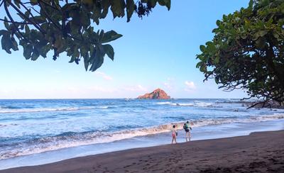 Koki beach - we came for the huli huli chicken, and stayed to play in the waves. The sand is a mix of red and dark gray.