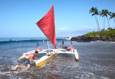 Outrigger canoe trip from Polo beach, Wailea. The canoe is launched directly from the sand, in the traditional style. It's more about skill and timing than brute force, so the father-son team running the trip didn't need our "help".