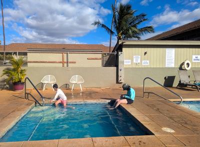 The temperamental hot tub at Kihei Bay Surf. The water was almost scalding on one day, only lukewarm on another. <br/> Dana is reading an actual paper book because her phone died two days into the trip.